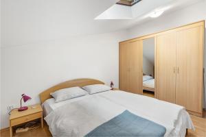 a bedroom with a large bed and a mirror at Apartment Luna in Poreč