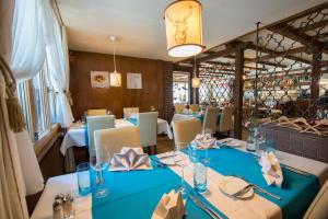 a dining room with blue tables and chairs at Hotel Sternen in Buochs