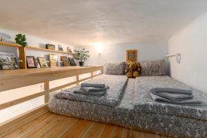 a bedroom with a large bed with a teddy bear on it at Westend apartment in Budapest