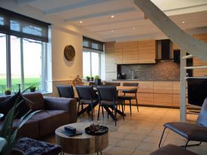 a living room with a couch and a table at Comfortable holiday home in Schoondijke in Schoondijke