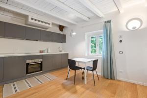 a kitchen with a table and two chairs at La Corte Apartment 1 in Peschiera Borromeo