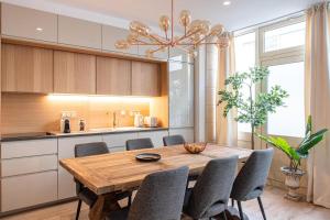 a dining room with a wooden table and chairs at My Cottage in Paris in Paris