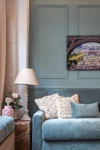 a blue couch in a living room with a lamp at My Cottage in Paris in Paris