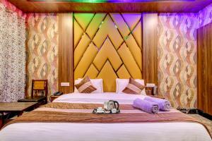 a bedroom with a large bed with a colorful wall at HOTEL ROYAL HAMEED in Srinagar