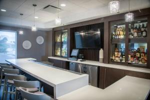 a bar in a restaurant with a counter and chairs at SpringHill Suites by Marriott Miami Airport South Blue Lagoon Area in Miami