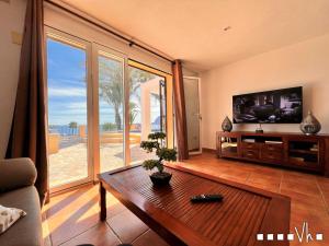 a living room with a flat screen tv and a table at VH CostaBlanca - EVA in Benissa