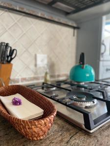 a wicker basket sitting on a counter next to a stove at Casa Balena - Gansbaai seafront accommodation, back-up power in Gansbaai