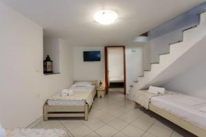 a room with two beds and a staircase at "Triacanthos" 2 bedroom house in Moutsoúna