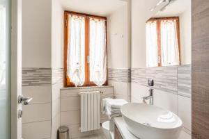 a white bathroom with a sink and a mirror at La Sapienza in Pistoia +13 photos