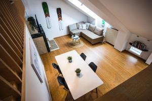 an overhead view of a living room with a table and chairs at URBAN LOFT // CITY CENTER // BEST LOCATION VILLACH in Villach