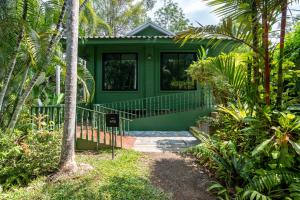 a green house in the middle of a garden at Blu Monkey Pooltara Krabi Hotel & Villas Pet Friendly in Tha Lane Bay