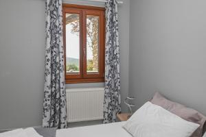 a bedroom with a bed and a window at Santamare Studio in Agios Sostis