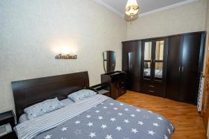 um quarto com uma cama grande e almofadas azuis em Barnaba Apartment em Tbilisi