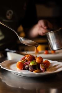 a plate of food with a spoon on a table at Locanda del Daino in Lemmi +12 photos