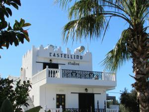 a white building with a balcony on top of it at Castellino Studios in Faliraki