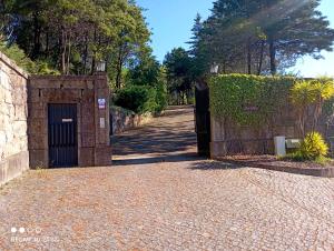 an entrance to a stone wall with a door at Casa do Monte in Vizela