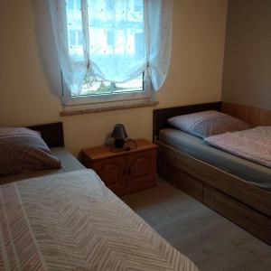 1 dormitorio con 2 camas y ventana en Dori's Fewo, en Mittenwalde
