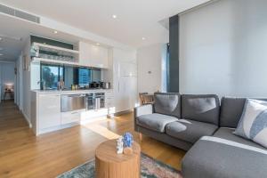 a living room with a couch and a table at South Melbourne Short Stay Luxury & Location 01728 in Melbourne