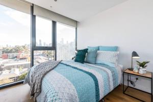 a bedroom with a bed and a large window at South Melbourne Short Stay Luxury & Location 01728 in Melbourne