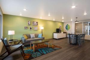 a living room with a couch and a table at WoodSpring Suites Grand Rapids Kentwood in Grand Rapids