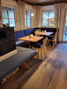 a restaurant with two tables and chairs and windows at Hotel Filser in Füssen