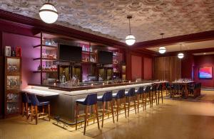 a bar in a restaurant with blue bar stools at Holston House Nashville, in The Unbound Collection by Hyatt in Nashville