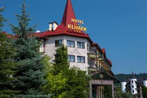 a building with a tower on top of it at Hotel Klimek Spa in Muszyna