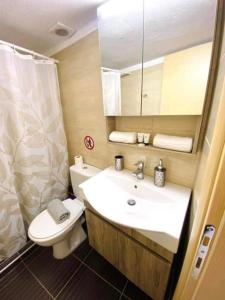 a bathroom with a sink and a toilet and a mirror at Jasmin Apartments Brown in Hanioti +7 photos