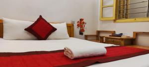 a bedroom with a bed with a red blanket on it at Thanh Hương 99 Hotel - Nội Bài in Hanoi