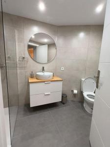 a bathroom with a sink and a toilet and a mirror at Appartement Vue mer PLAYA MAR in Torremolinos