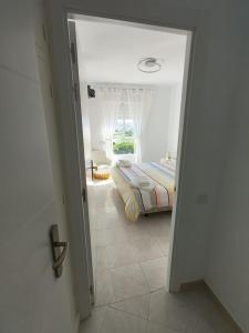 a door to a bedroom with a bed in a room at Appartement Vue mer PLAYA MAR in Torremolinos