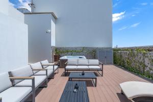 a patio with white lounge chairs and a pool at Beach Walk Boutique Jumeirah in Dubai