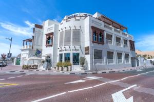 a white building on the corner of a street at Beach Walk Boutique Jumeirah in Dubai
