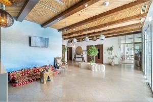 a living room with couches and a blue wall at Beach Walk Boutique Jumeirah in Dubai