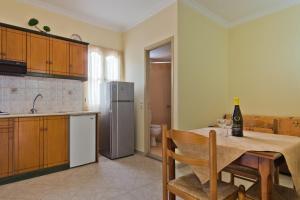 a kitchen with a table with a bottle of wine on it at Sea Melody in Lefkos Karpathou