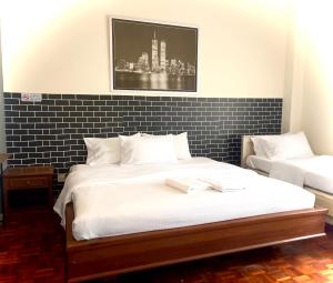 a bedroom with two beds and a black and white at Selesa hill homestay in Bentong