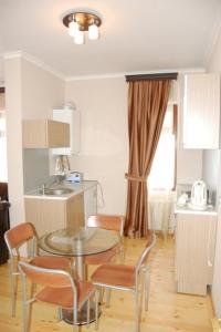 a kitchen with a table and chairs and a sink at Qusar Olimpik Hotel and Cottages in Qusar