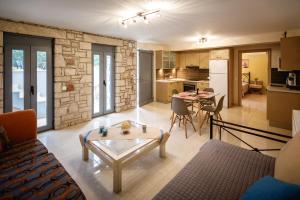 a living room with a table and a kitchen at Gravaris House in Nafplio