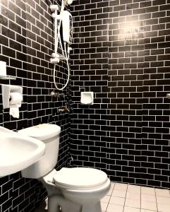 a bathroom with a white toilet and a sink at Selesa hill homestay in Bentong