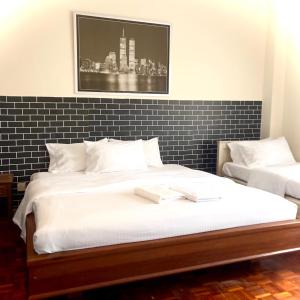 a bedroom with a large bed with white sheets at Selesa hill homestay in Bentong
