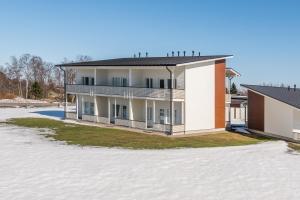 a house on top of a field of snow at Villa Kartano in Raahe