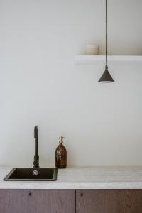 a kitchen with a sink and a counter top at Cabin Water Zuidermeer in Zuidermeer