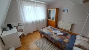 Vila Bbq في ليوبليانا: غرفة نوم صغيرة مع سرير وطاولة