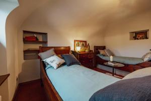 a bedroom with two beds and a table with a lamp at Locanda del Daino in Lemmi