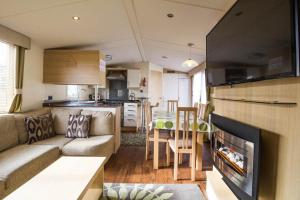 a living room with a couch and a kitchen at Brilliant 8 Berth Caravan At Haven Caister Holiday Park In Norfolk Ref 30024d in Great Yarmouth
