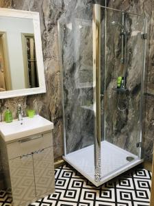 a shower with a glass door in a bathroom at The Forester and Flower in Bath