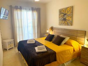 a bedroom with a large bed with two towels on it at Dream Apartment in Mijas Golf Limonar in Mijas Costa