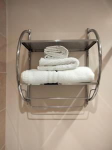 a group of towels on a towel rack in a bathroom at The Overlook Bed and Breakfast in Glastonbury