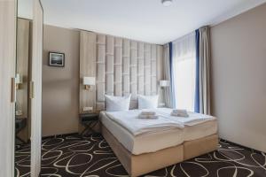 Postel nebo postele na pokoji v ubytování Trofana Wellness & SPA + 37 fotografií