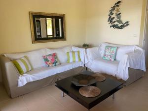 a living room with a white couch and a table at Athinaios Porto Klisouri Villa in Ierissos